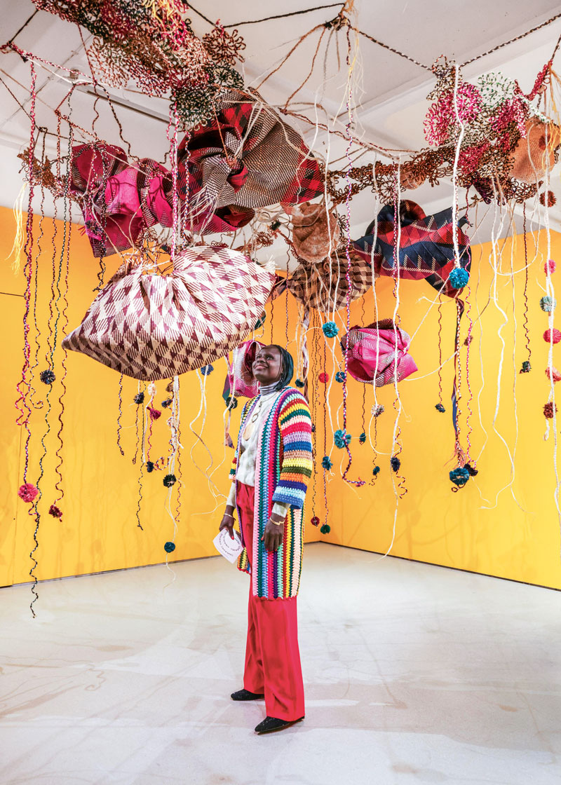 Acaye Kerunen with her work Ayelele (2023) at the Barbican Centre in London.
